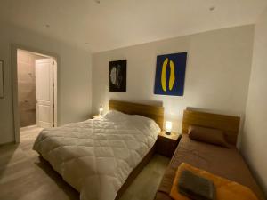 a bedroom with a large bed and two night stands at Beach House. Live, experience sea in St Paul's Bay