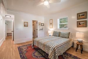 a bedroom with a bed and a ceiling fan at Cozy Beach House Steps from the Shore: 4 Bedroom in Pawleys Island