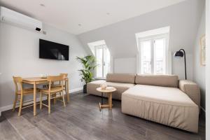 a living room with a couch and a table at Hausd - Soho in London