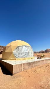 a tent sitting in the middle of the desert at Rum Mars camp in Wadi Rum
