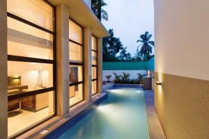 a swimming pool in the middle of a house at Luxury Villa Goa in Candolim