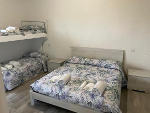 a bedroom with two beds and two bunk beds at VILLA IL TUFO in Siena
