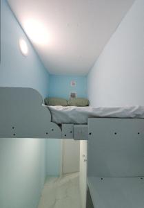 a small room with a bed in the ceiling at Al Khaleez Accommodation in Dubai