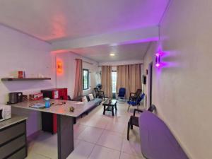 a kitchen and living room with a purple ceiling at Ashan Luxury Seafront Villa 1 in Grande Rivière Sud Est