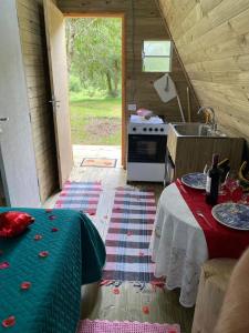 a small kitchen with a table and a stove at Sítio flor da montanha in São Bento do Sapucaí +9 photos