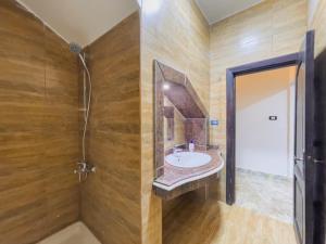 a bathroom with a sink and a shower at hermanos pyramids view in Cairo