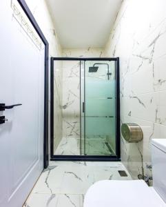 a bathroom with a glass shower and a toilet at Mia Mia Suites in Istanbul