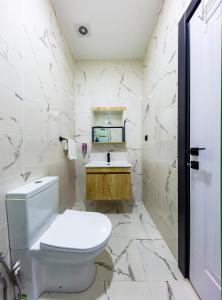 a white bathroom with a toilet and a sink at Mia Mia Suites in Istanbul