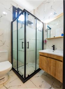 a bathroom with a glass shower and a toilet at Mia Mia Suites in Istanbul