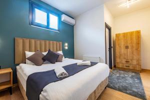 a bedroom with a large bed with a blue wall at Mia Mia Suites in Istanbul