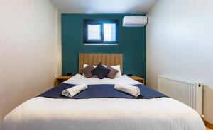 a bedroom with a large bed with blue walls at Mia Mia Suites in Istanbul