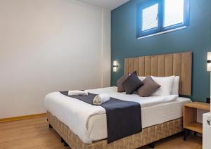 a bedroom with a large bed with blue walls at Mia Mia Suites in Istanbul