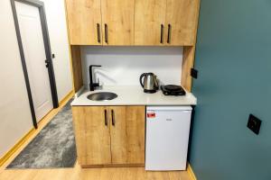 a small kitchen with a sink and a refrigerator at Mia Mia Suites in Istanbul