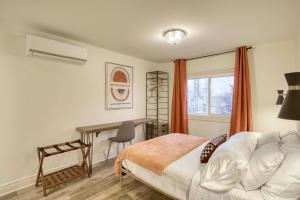 a bedroom with a bed and a desk and a window at Comfort Home Stays in Lincoln Niagara in Beamsville