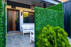a garden with a bench and a green hedge at Mia Mia Suites in Istanbul
