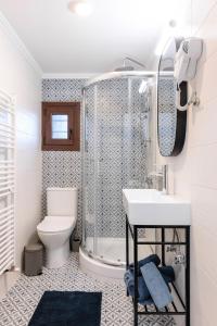 a bathroom with a shower and a sink and a toilet at Άρνη (η κόρη του Αιόλου) in Arnaia