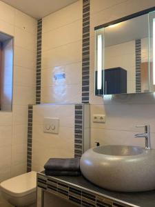 a bathroom with a sink and a toilet and a mirror at Ferienwohnungen LARA Wohnung 2 in Wallgau