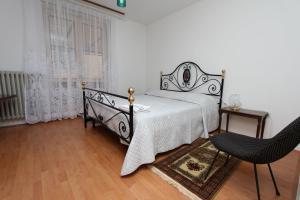 a bedroom with a bed and a table and a chair at Apartment Key in Rovinj