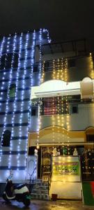 a building with lights on the side of it at Srinivas service home in Rājahmundry