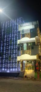 a building with blue lights on it at night at Srinivas service home in Rājahmundry