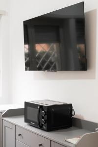a microwave sitting on top of a table at Aurelia Deluxe Suites in Rome