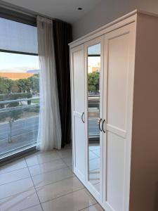 a room with a large glass door with a window at FIRA Gran Vía 2 - Private Rooms in a Shared Apartment - Habitaciones Privadas en Apartamento Compartido in Hospitalet de Llobregat