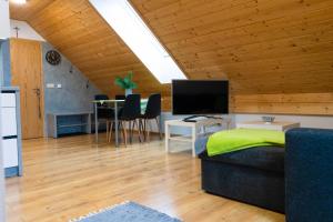 a room with a bed and a table with chairs at Apartmány Bobrík in Liptovský Mikuláš