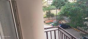 a balcony with a car parked in a yard at Executive home Stay Sector75 Noida in Noida