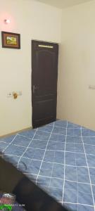 a bed in a room with a blue tiled floor at Executive home Stay Sector75 Noida in Noida