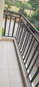 a metal railing on a balcony with a sidewalk at Executive home Stay Sector75 Noida in Noida