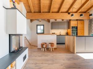 una cucina con armadi bianchi e soffitto in legno di Wagrainer TauernLodge 1 a Wagrain