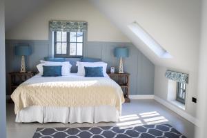 a bedroom with a large bed with blue pillows at Lakeview Barn, sleeps 5-7 Guests new inside in Matlock