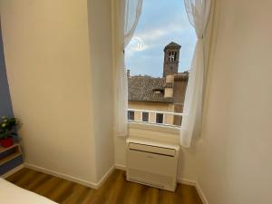 a room with a window with a view of a building at Belltower Elegans in Rome