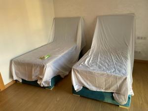 two beds in a room with white sheets at Résidence taourirt Taghazoute bay in Taghazout