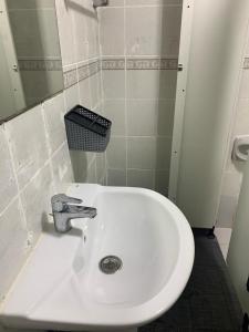 un lavandino bianco in un bagno con specchio di UAE HOSTEL a Dubai