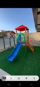 ein Spielplatz mit einer Rutsche auf einem Dach in der Unterkunft Areias de Bombas in Bombinhas