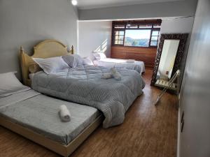 een slaapkamer met 2 bedden en een spiegel bij Apartamento a 150m da Rua Coberta in Gramado