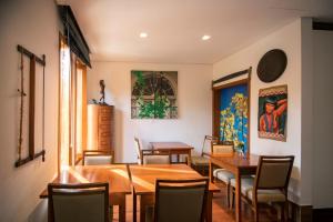 a dining room with wooden tables and chairs at Pousada Déllis in Visconde De Maua