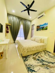 a bedroom with a bed and a ceiling fan at THE PINE HOUSE in Kuala Berang