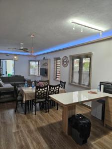 a kitchen and living room with a table and chairs at AP Villa Tourist Residence 16467 in Flic-en-Flac