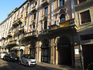 a white car parked in front of a building at Hotel Europa in Sesto San Giovanni