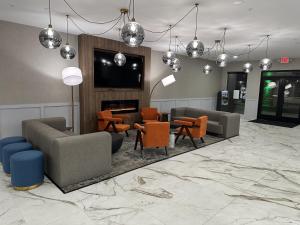 a lobby with couches and chairs and a fireplace at Quality Inn & Suites Lake Havasu City in Lake Havasu City