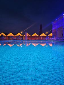 a large swimming pool at night with tents in the background at Aroma Butik Hotel in Kızılot