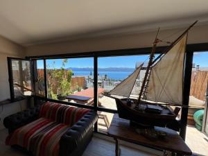 a living room with a pirate ship on the wall at MINI LOFT Departamentos Bariloche in San Carlos de Bariloche