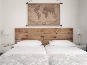 two beds in a bedroom with a map on the wall at Apartamento en Puerta del Sol 2 in Madrid