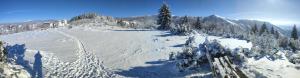 a snow covered mountain with trees and mountains at Apartman Standard u Kraljevim Čardacima in Kopaonik