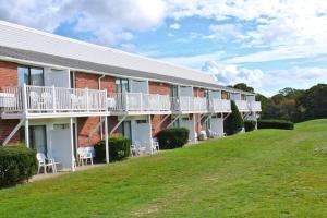 a building with a lawn in front of it at Cape Cod Irish Village - The Emerald Resort in Barnstable