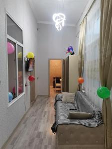 a living room with a couch and a chandelier at Eminera Hostels Baku in Baku