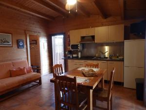 a kitchen and dining room with a table and a couch at Poioruivo in Santa Clara-a-Velha