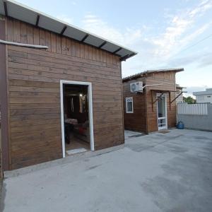 a wooden building with a patio and a door at Dunas Tiny House Casa 2 in Florianópolis